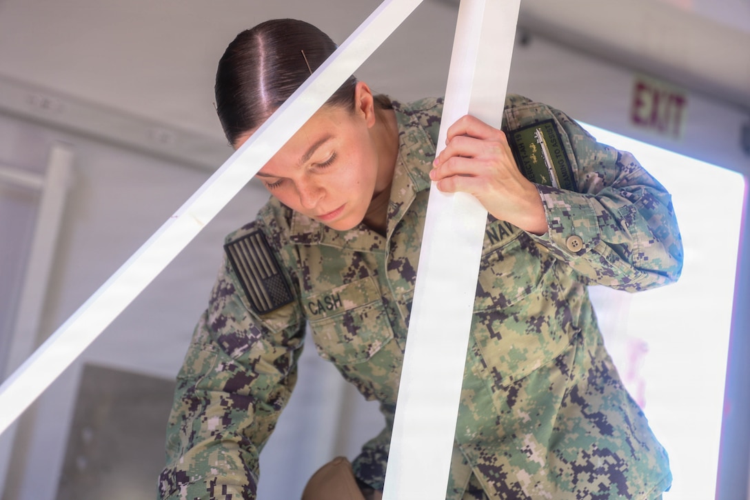 U.S. Navy Hospital Corpsman 3rd Class Julia Cash, assigned to the hospital ship USNS Mercy (T-AH 19), assembles a Rapid Emplacement Medical (REM) during Exercise Steel Knight at Naval Air Station North Island in Coronado, California, Dec. 2, 2025. The Marine Corps Warfighting Laboratory/Futures Directorate examines future operating environments to generate threat-informed operating concepts and capabilities and, through experimentation, provide analytically supported recommendations to inform future force design and development activities. (U.S. Marine Corps photo by Cpl. Michael Bartman)