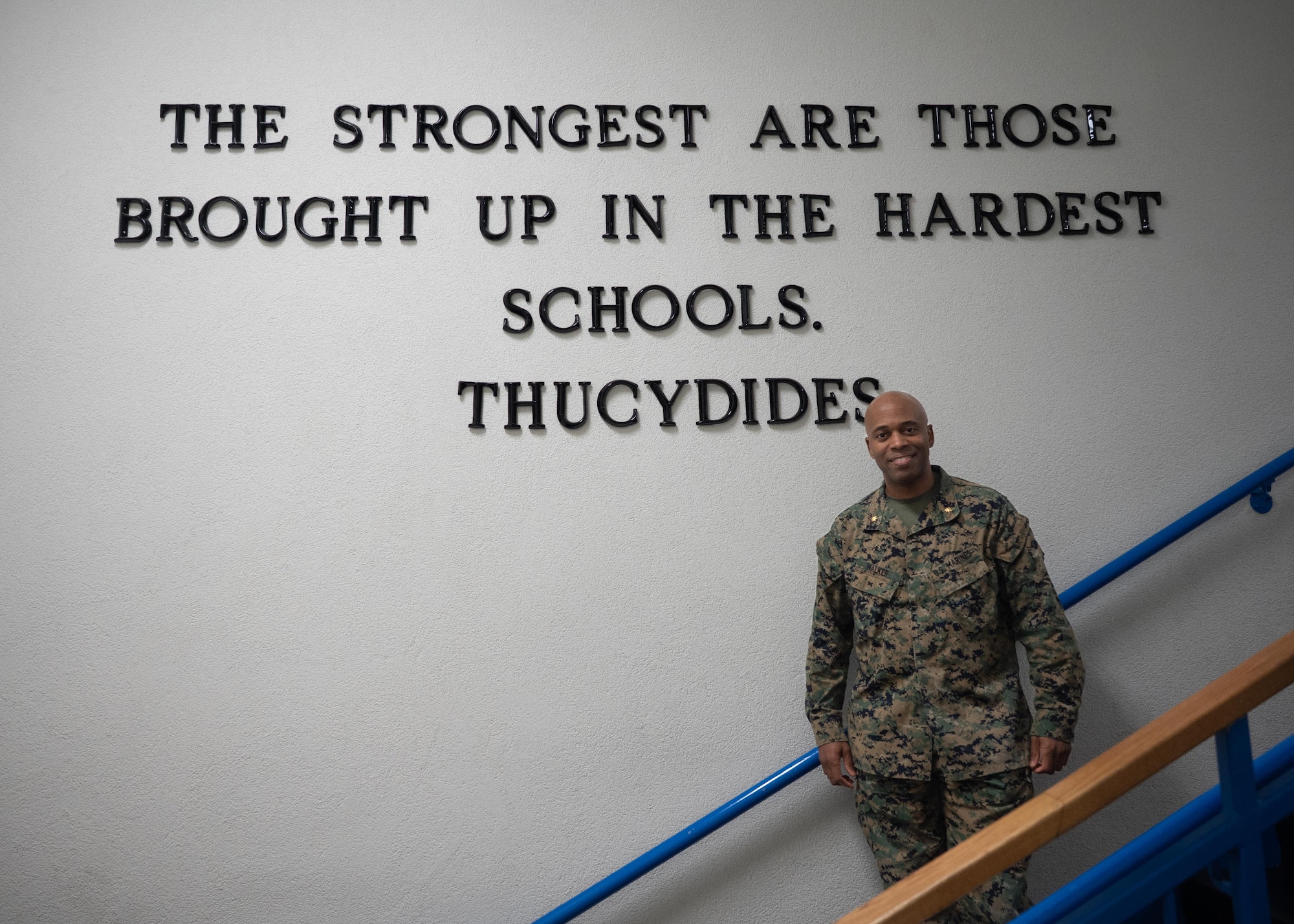 U.S. Marine Corps Maj. Cory Walker, School of Advanced Air and Space Studies student, poses for a photo beneath a quote by Thucydides at Maxwell Air Force Base, Alabama, Feb. 10, 2026.