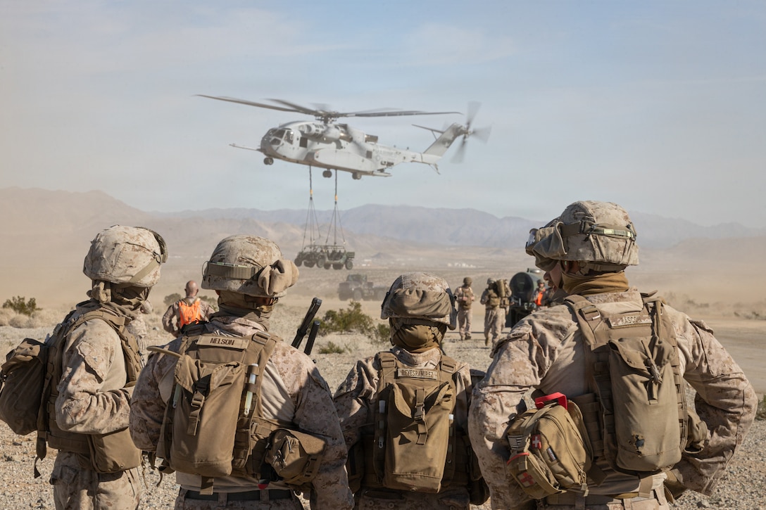 U.S. Marines with Combat Logistics Battalion 7, Combat Logistics Regiment 1, I Marine Expeditionary Force, observe a CH-53K King Stallion lift an Ultra Light Tactical Vehicle during an Air Logistics Course as part of Service Level Training Exercise 1-26 at Marine Corps Air Ground Combat Center, Twentynine Palms, California, Jan. 19, 2026. SLTE is designed to be a challenging, realistic training environment that produces combat-ready forces capable of operating as an integrated Marine Air Ground Task Force. (U.S. Marine Corps photo by Cpl. Connor Webb)