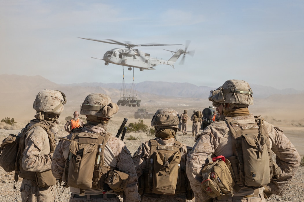 U.S. Marines with Combat Logistics Battalion 7, Combat Logistics Regiment 1, I Marine Expeditionary Force, observe a CH-53K King Stallion lift an Ultra Light Tactical Vehicle during an Air Logistics Course as part of Service Level Training Exercise 1-26 at Marine Corps Air Ground Combat Center, Twentynine Palms, California, Jan. 19, 2026. SLTE is designed to be a challenging, realistic training environment that produces combat-ready forces capable of operating as an integrated Marine Air Ground Task Force. (U.S. Marine Corps photo by Cpl. Connor Webb)