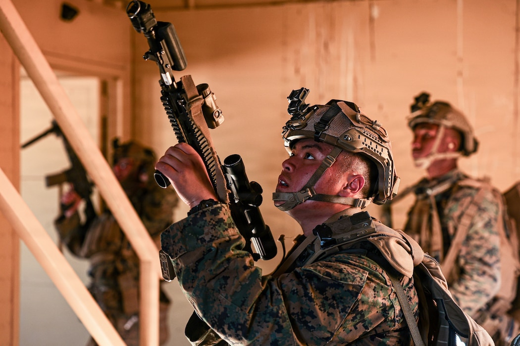 U.S. Marine Corps Lance Cpl. Erick Moua, a California native, infantry Marine with 1st Battalion, 8th Marines, 6th Marine Regiment, prepares to clear the second floor while conducting company-level urban assault during Adversary Force Exercise 1-26 as part of Service Level Training Exercise 1-26 at Range 220, Marine Corps Air Ground Combat Center, Twentynine Palms, California, Feb. 4, 2026. The urban environment of Range 220 trains Marines to safely conduct urban operations and challenges leaders to make rapid decisions. (U.S. Marine Corps photo by Lance Cpl. Cody Fitzgerald)
