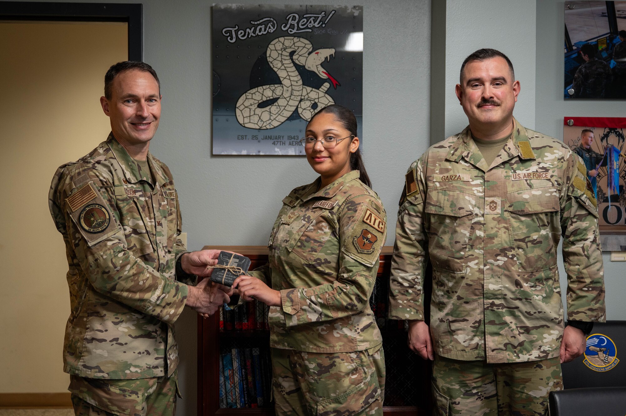 An Airman is presented an award for the dorm of the fourth quarter.