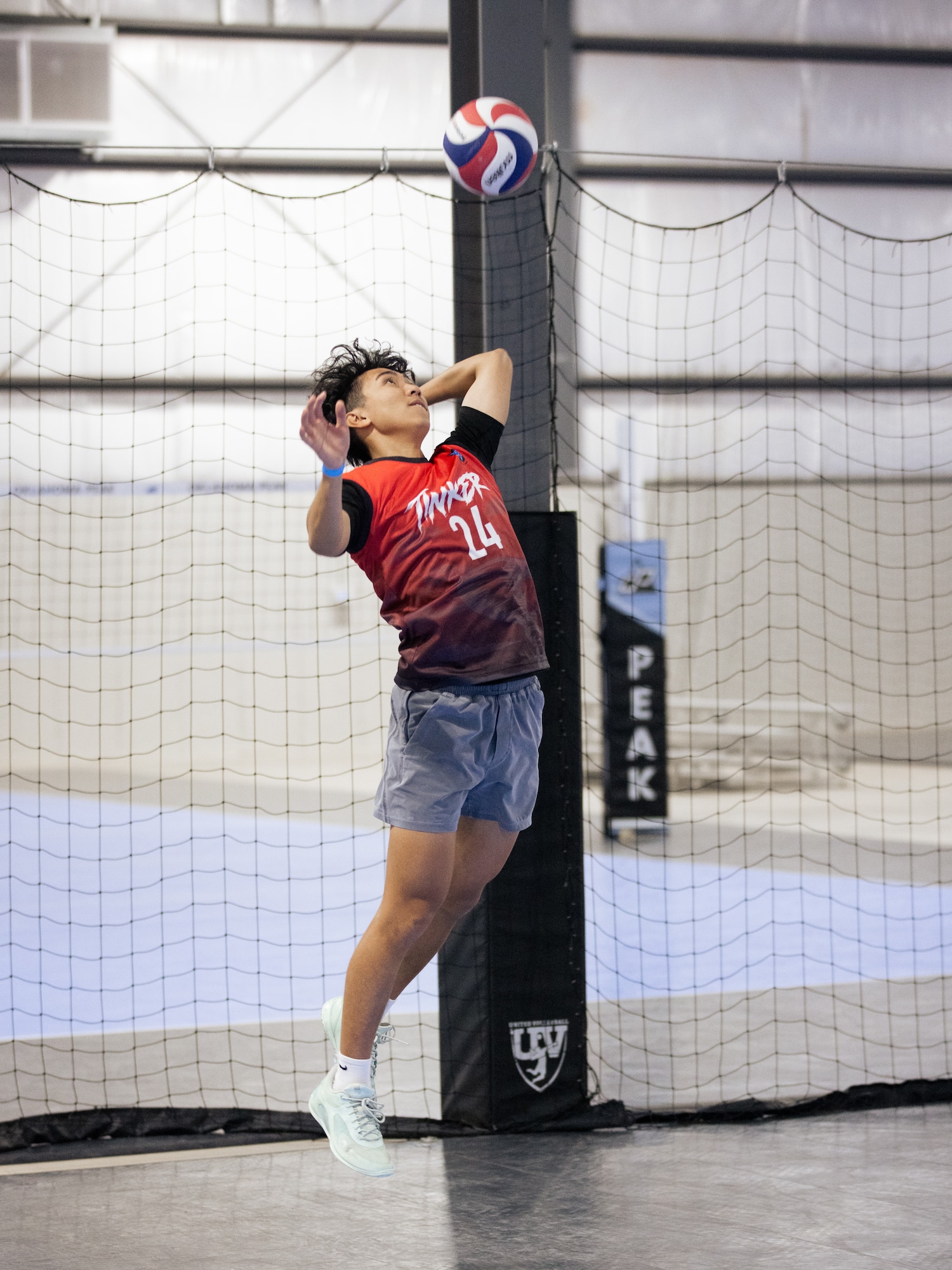 man jumps to hit ball