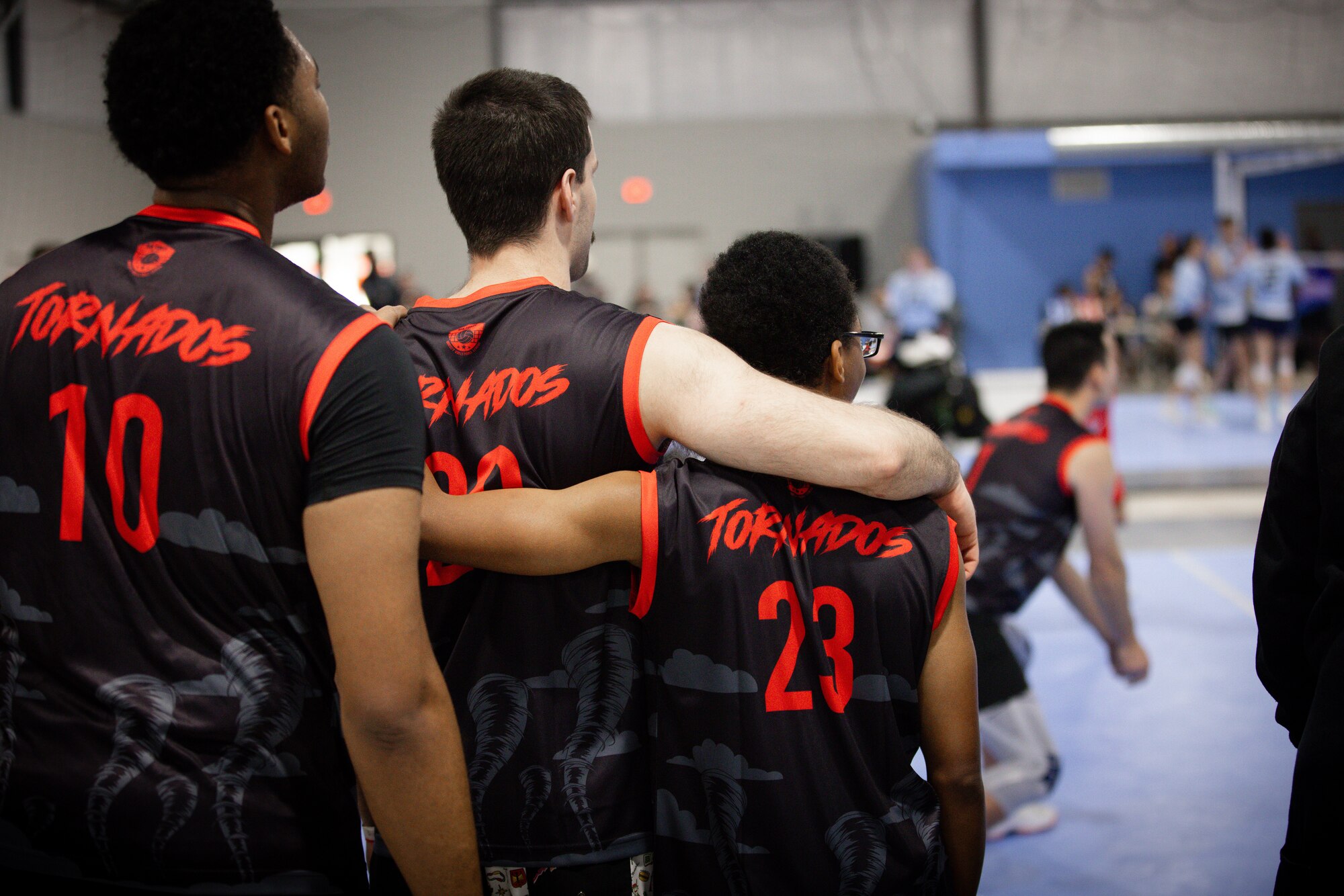 Two people arms crossed over shoulders