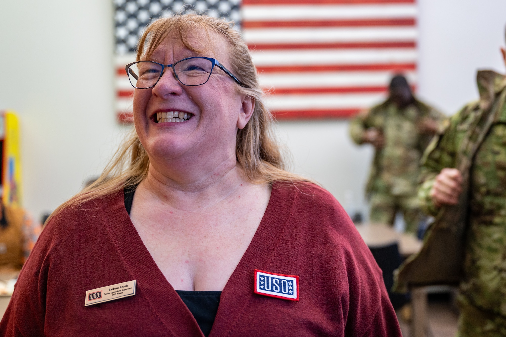 Barbara Knaak, USO Alaska center operations supervisor, speaks to volunteers during an event at the Elmendorf USO at Joint Base Elmendorf-Richardson, Alaska, Feb. 11, 2026. The event highlighted a decade of USO support to service members and their families stationed at JBER. (U.S. Air Force photo by Senior Airman Hunter Hites)