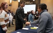DAHLGREN, Va. – An employee connects with a department representative during an internal New Employee Development Program job fair hosted by Naval Surface Warfare Center Dahlgren Division at the University of Mary Washington Dahlgren campus. The initiative enables temporary cross-functional rotations to expand mission awareness and support professional development across the command. (Tierney Kunstmann/NSWCDD Photo)