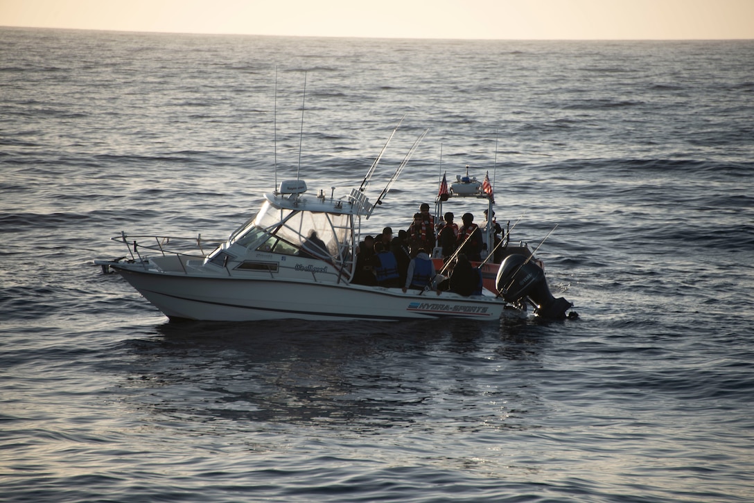 A vessel with suspected illegal migrants is boarded by the Coast Guard.