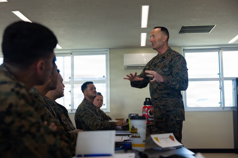 U.S. Marine Corps Sgt. Maj. Christopher Adams, sergeant major of III Marine Expeditionary Force, talks to leaders during a staff sergeant symposium on Marine Corps Air Station Futenma, Okinawa, Japan, Jan. 15, 2026. Staff sergeants with 1st MAW gathered to receive professional development classes focused on strengthening leadership skills and reinforcing their roles as mentors to Marines. (U.S. Marine Corps photo by Lance Cpl. Carlos Paz-Sosa)