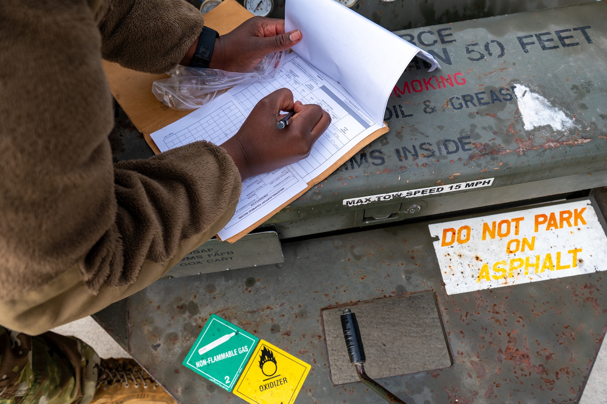 A military member fills out a form.
