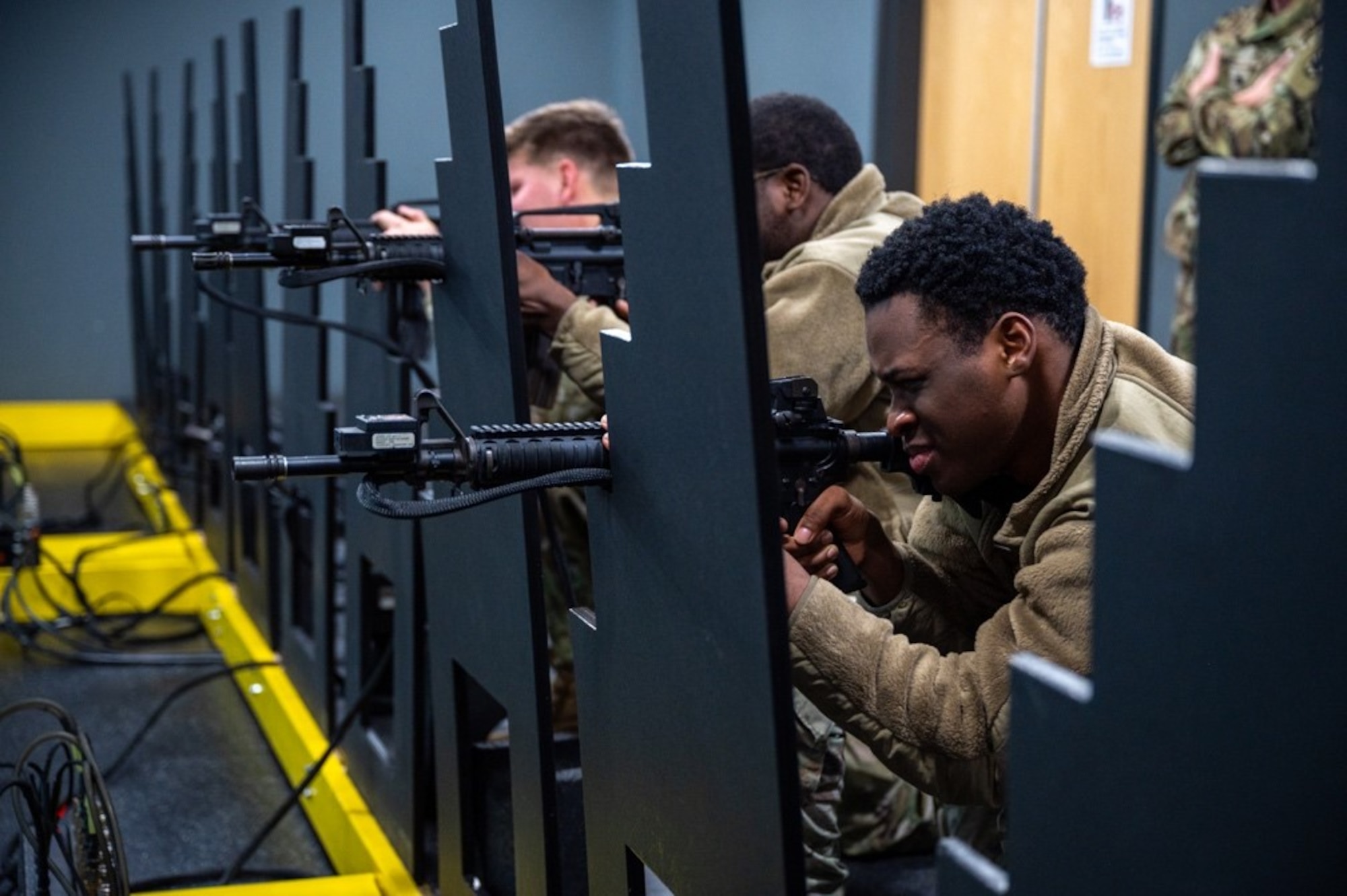 Soldiers aim M-4 replicas while kneeling. (U.S. Air Force photo by Airman 1st Class Donnell Ramsey)