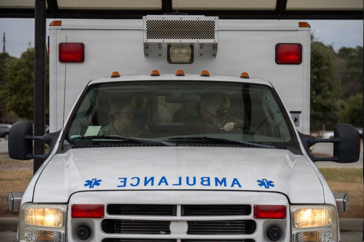 Master Sgt. Sarah Thompson, 4th Medical Group Flight Medicine flight chief, and Staff Sgt. Anicia Roberson, 4th Medical Group medical technician, demonstrates ambulance flight line response to an in-flight emergency or ground emergency outside of the 4th Medical Group at Seymour Johnson Air Force Base, N.C. Jan. 23, 2026. Flight Medicine personnel at the 4th Medical Group train to respond to flight line emergencies within five minutes of notification for trusted and speedy care. (U.S. Air Force photo by 2nd Lt. Jason Pannell).