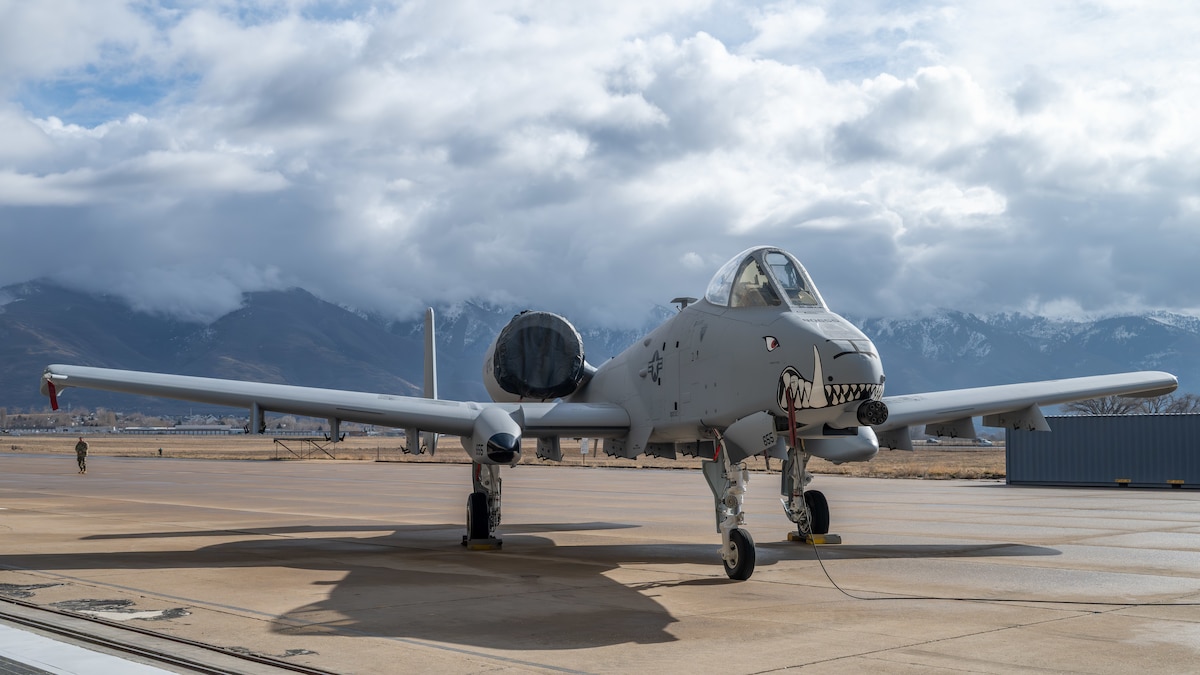 An A10 Aircraft with painted teeth on nose positioned in front of mountains