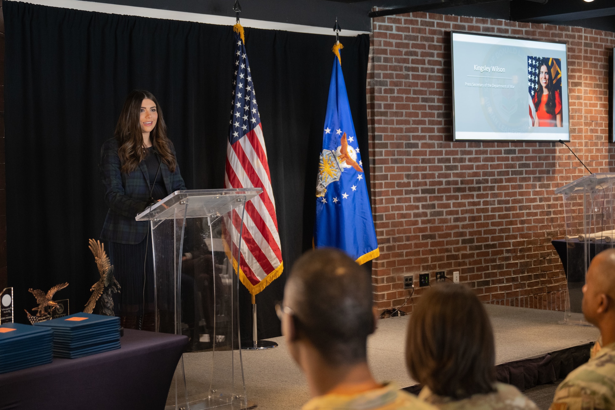 A woman stands at a podium.