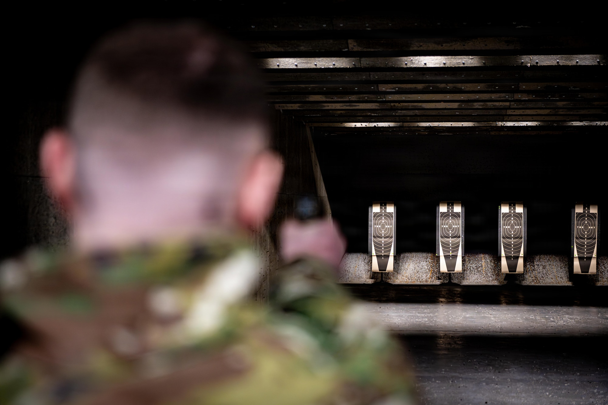 U.S. Air Force Airman 1st Class Dalton Stratman, 35th Maintenance Squadron aircraft structural maintenance journeyman, fires an M18 service pistol during a competition in honor of Presidents Day.