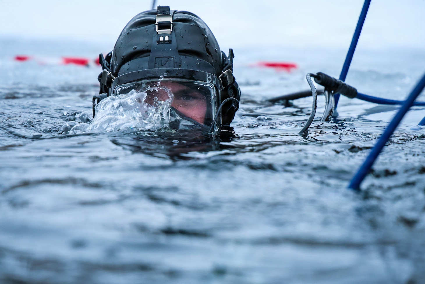 A U.S. Navy Seabee Diver from Underwater Construction Team One conducts an ice dive in a frozen lake during a bilateral training exchange with Estonian divers at Rummu Quarry Lake, Estonia.