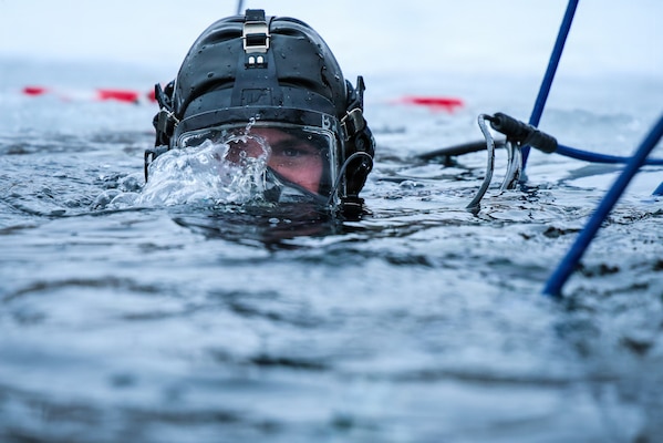 A U.S. Navy Seabee Diver from Underwater Construction Team One conducts an ice dive in a frozen lake during a bilateral training exchange with Estonian divers at Rummu Quarry Lake, Estonia.