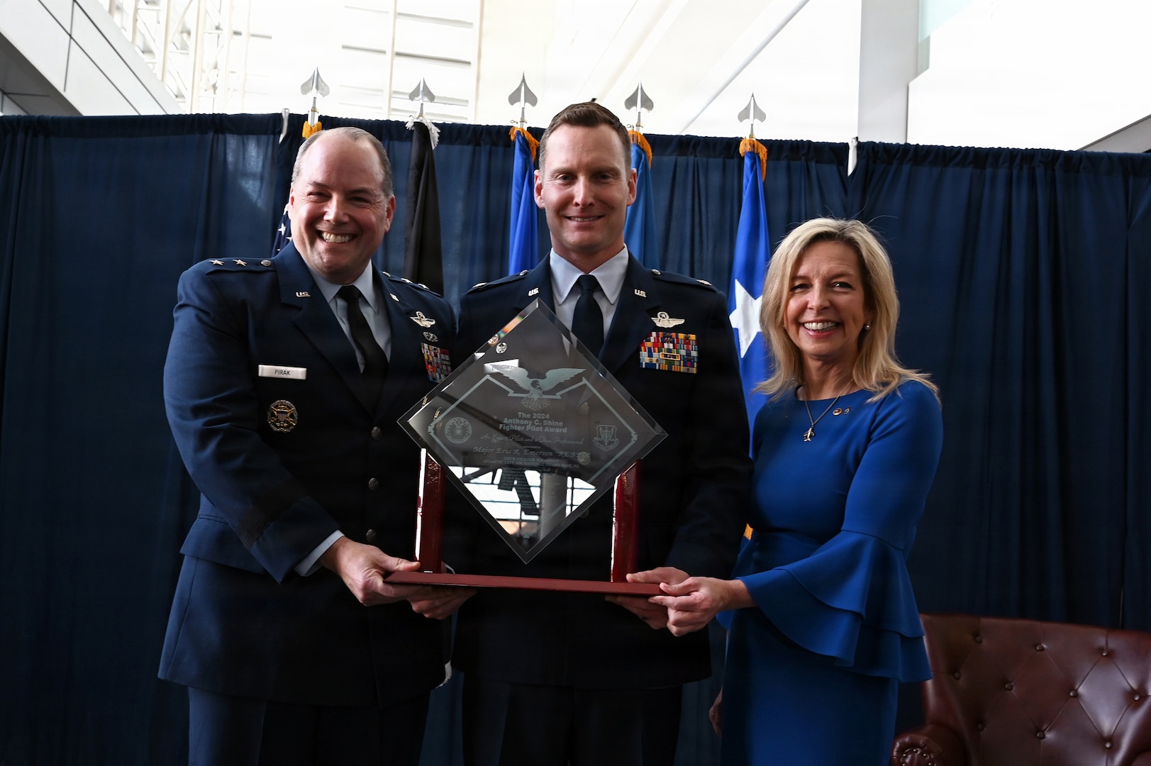 From left, U.S. Air Force Maj. Gen. Duke Pirak, acting director, Air National Guard; Lt. Col. Eric “Rebel” Emerson, commander, 119th Fighter Squadron, 177th Fighter Wing, New Jersey National Guard; and Colleen Shine showcase the 2024 Lt. Col. Anthony C. Shine Fighter Pilot Award during a ceremony at Joint Base Andrews, Maryland, Feb. 10, 2026.