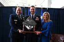 From left, U.S. Air Force Maj. Gen. Duke Pirak, acting director, Air National Guard; Lt. Col. Eric “Rebel” Emerson, commander, 119th Fighter Squadron, 177th Fighter Wing, New Jersey National Guard; and Colleen Shine showcase the 2024 Lt. Col. Anthony C. Shine Fighter Pilot Award during a ceremony at Joint Base Andrews, Maryland, Feb. 10, 2026.