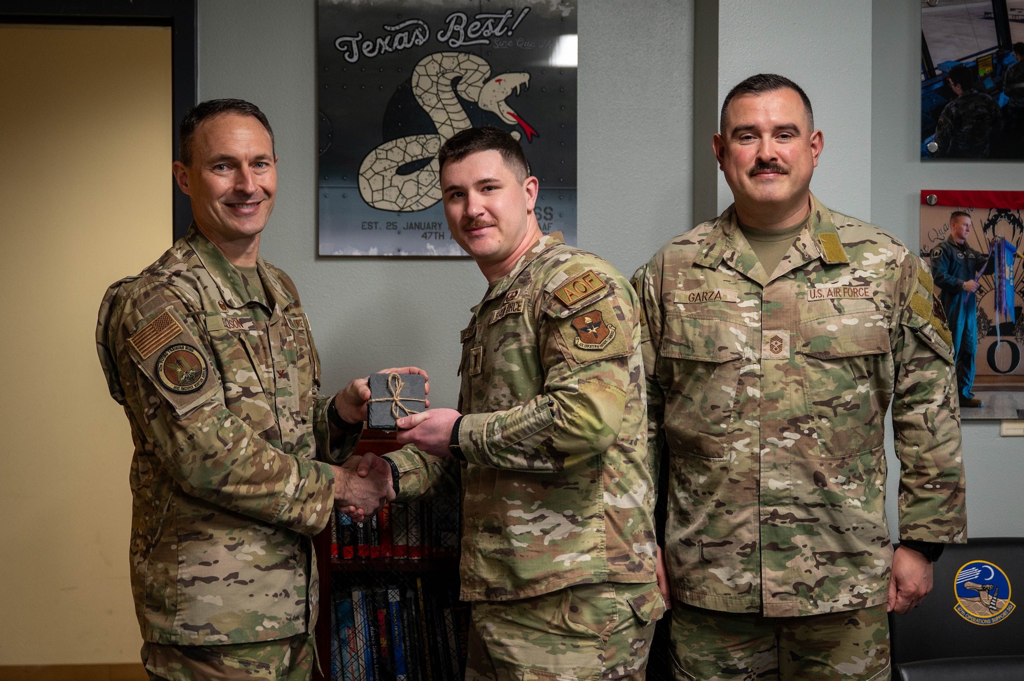 An Airman is presented an award as company grade officer of the fourth quarter.