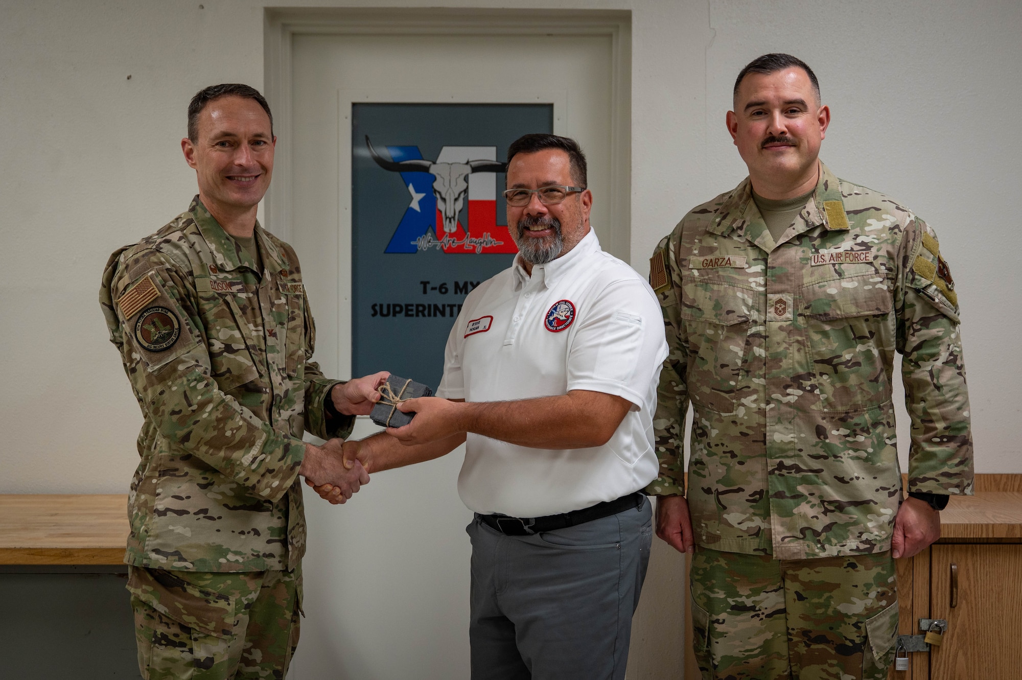 An civilian is presented an award as the category II supervisory civilian of the quarter of the fourth quarter.