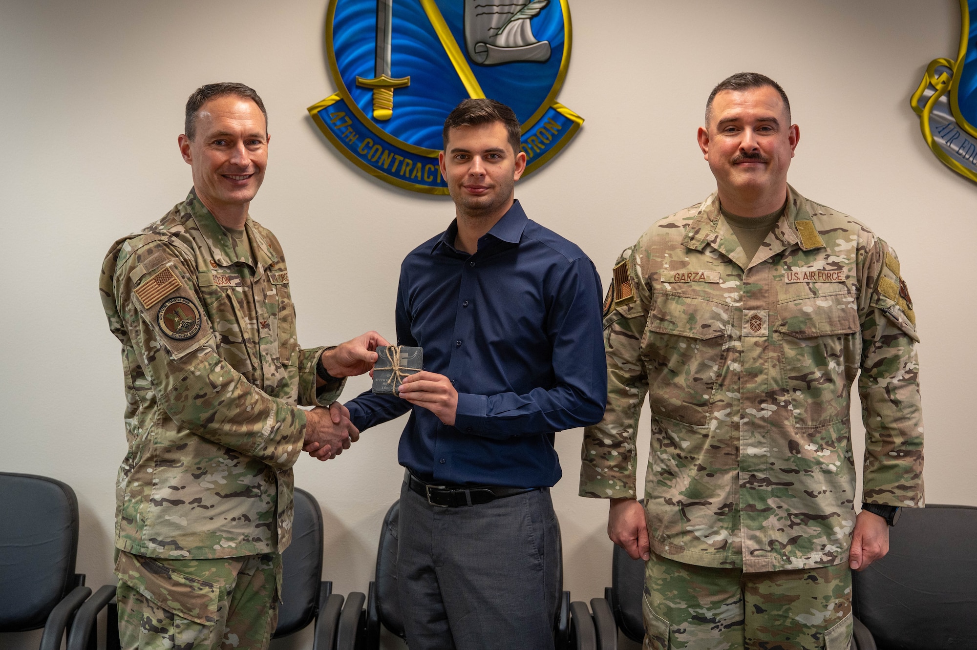 An civilian is presented an award as the category III supervisory civilian of the quarter of the fourth quarter.