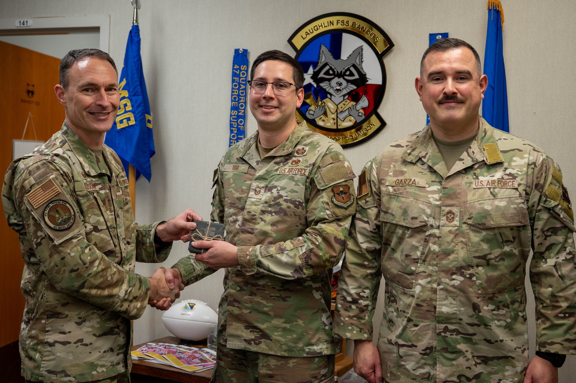 An Airman is presented an award as Senior NCO of the fourth quarter.