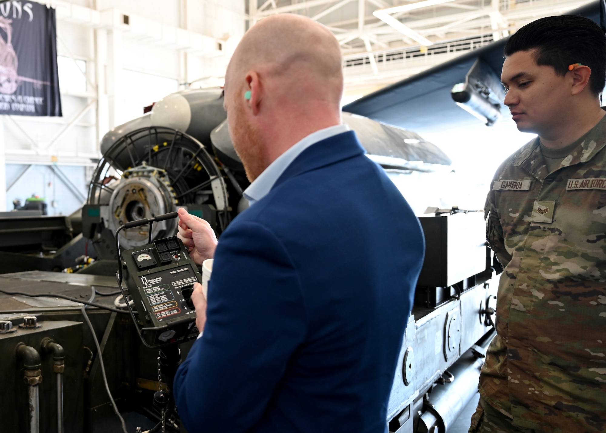 A Kansas City National Security Campus team member examines a portable control unit