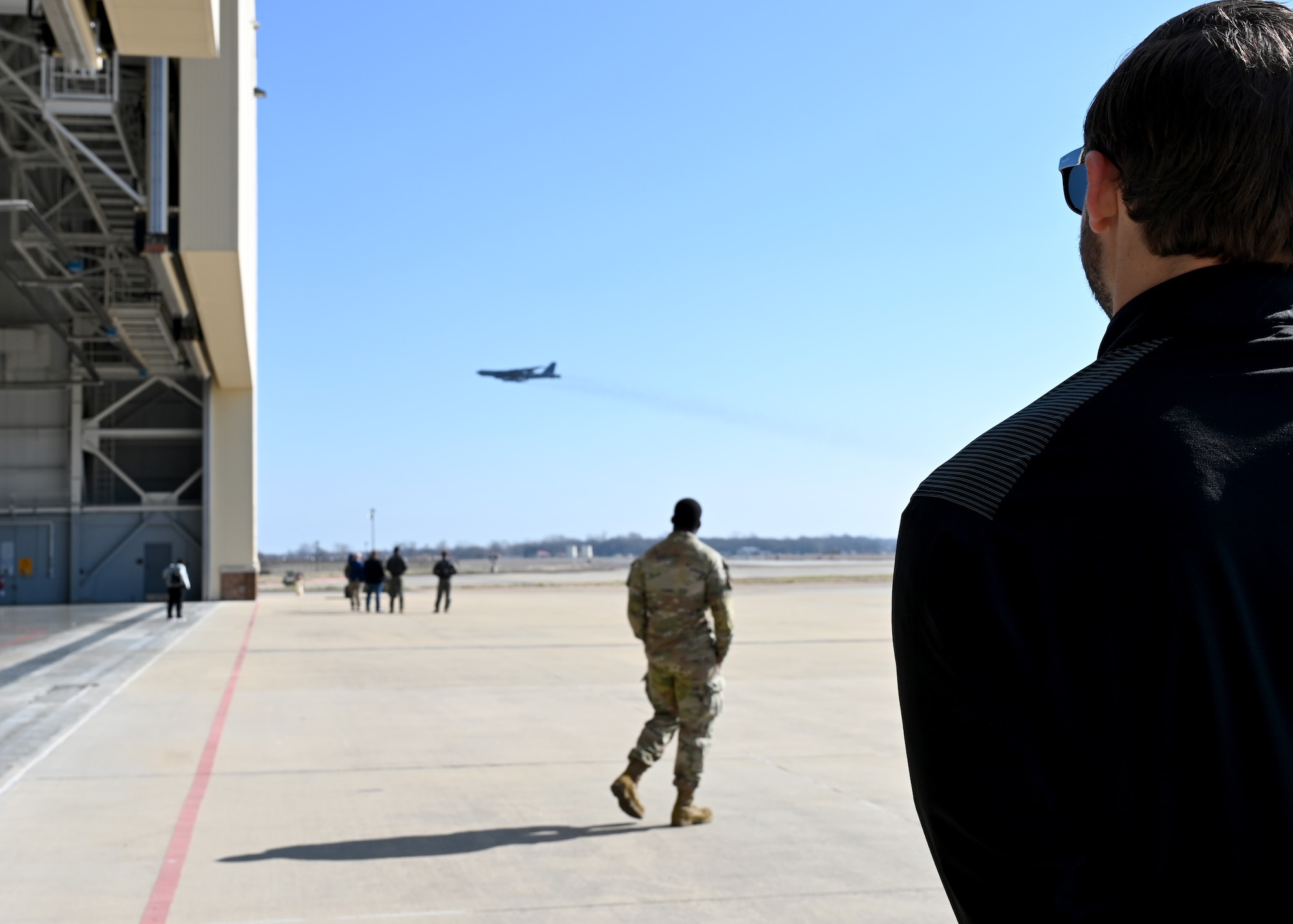 Personnel watch a B-52 Stratofortress take off