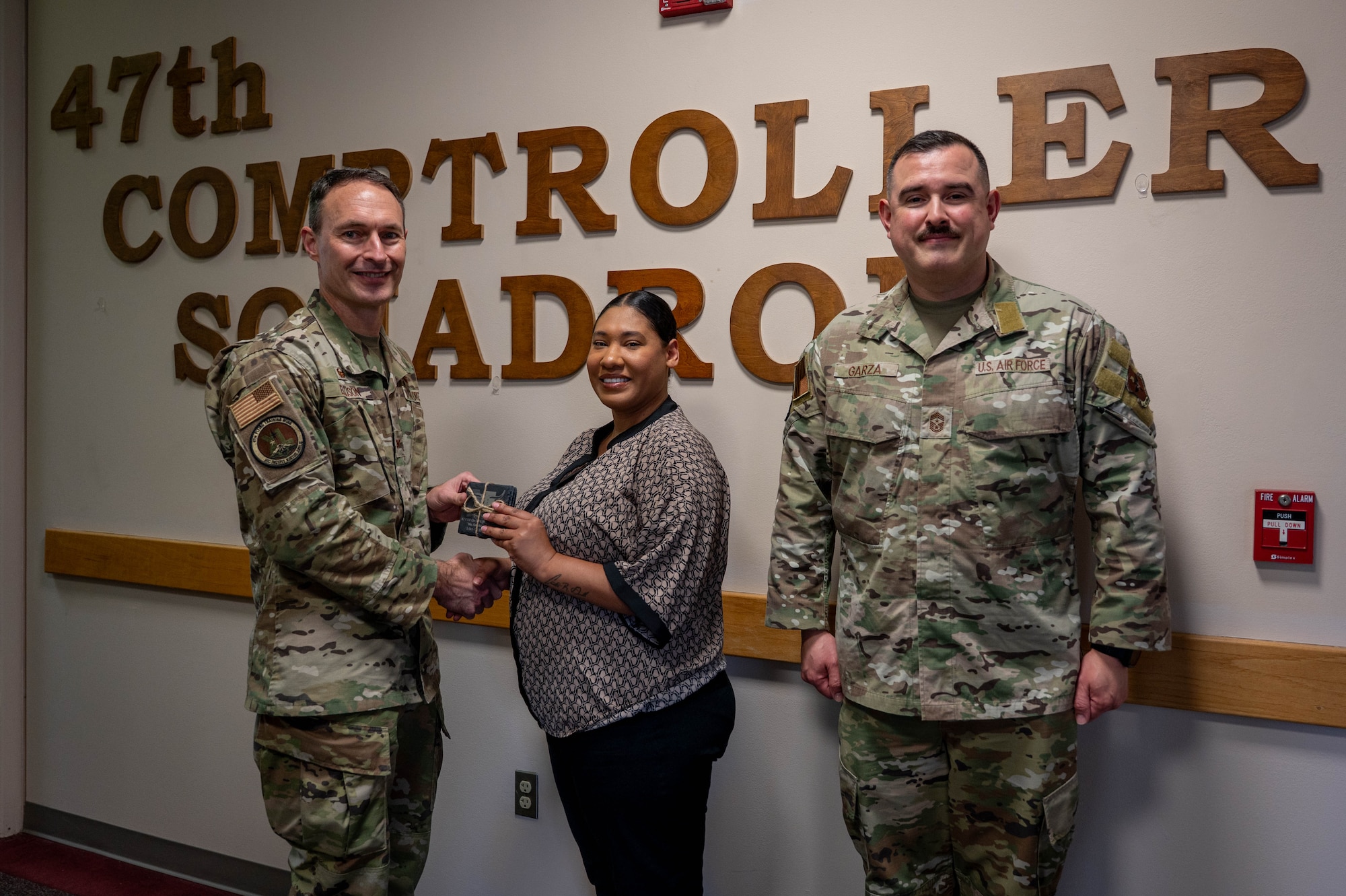 An civilian is presented an award as the category I non-supervisory civilian of the quarter of the fourth quarter.