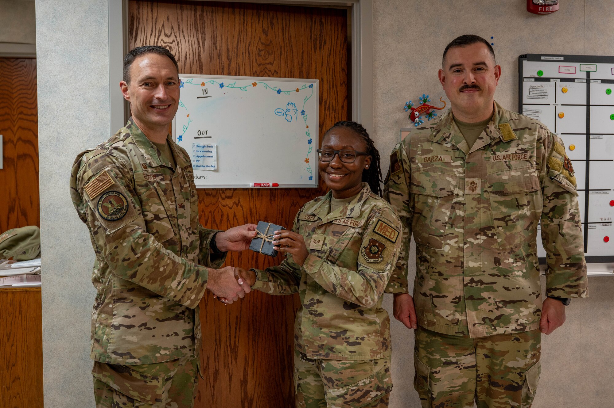An Airman is presented an award as volunteer of the fourth quarter.