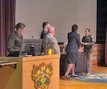 Pfc. Paulina Cazarez Curiel (far right), honor graduate, receives her diploma during a Practical Nurse Course graduation ceremony held at the NCO Leadership Center of Excellence.