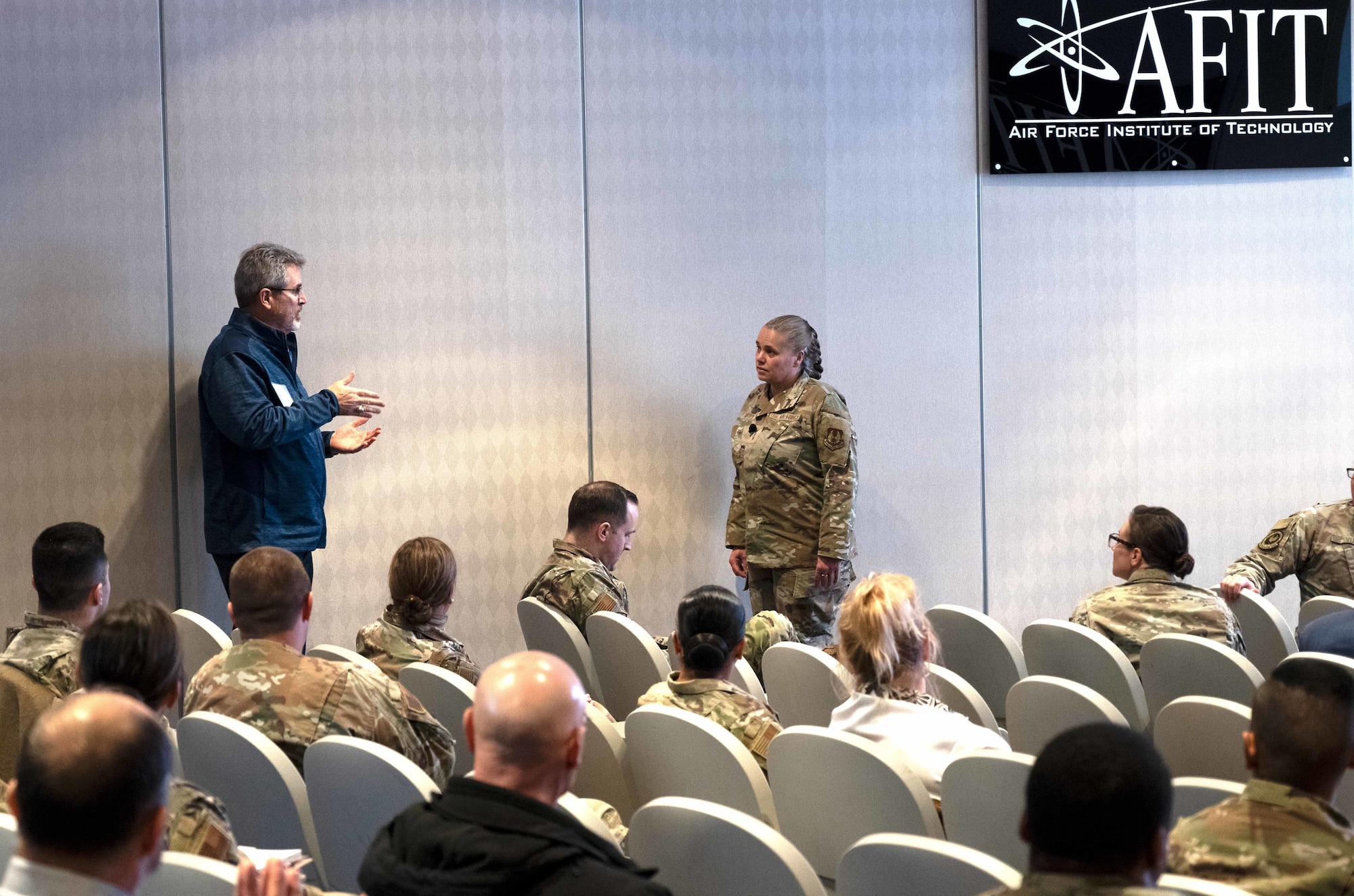 A man asks a questions to a female Airman.