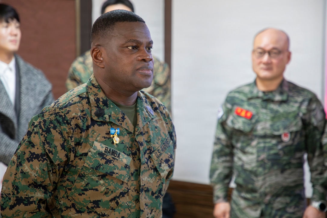 U.S. Marine Corps Sgt. Maj. Ismael G. Bamba, command senior enlisted leader of Marine Forces Korea, stands at attention as his citation is read during his award ceremony at Republic of Korea Marine Corps Headquarters at Camp Baran, South Korea, Feb. 3, 2026. The commendation highlights significant efforts supporting regional stability, alliance readiness and combined operational effectiveness on the Korean Peninsula. (U.S. Marine Corps photo by Gunnery Sgt. Antonio Campbell)