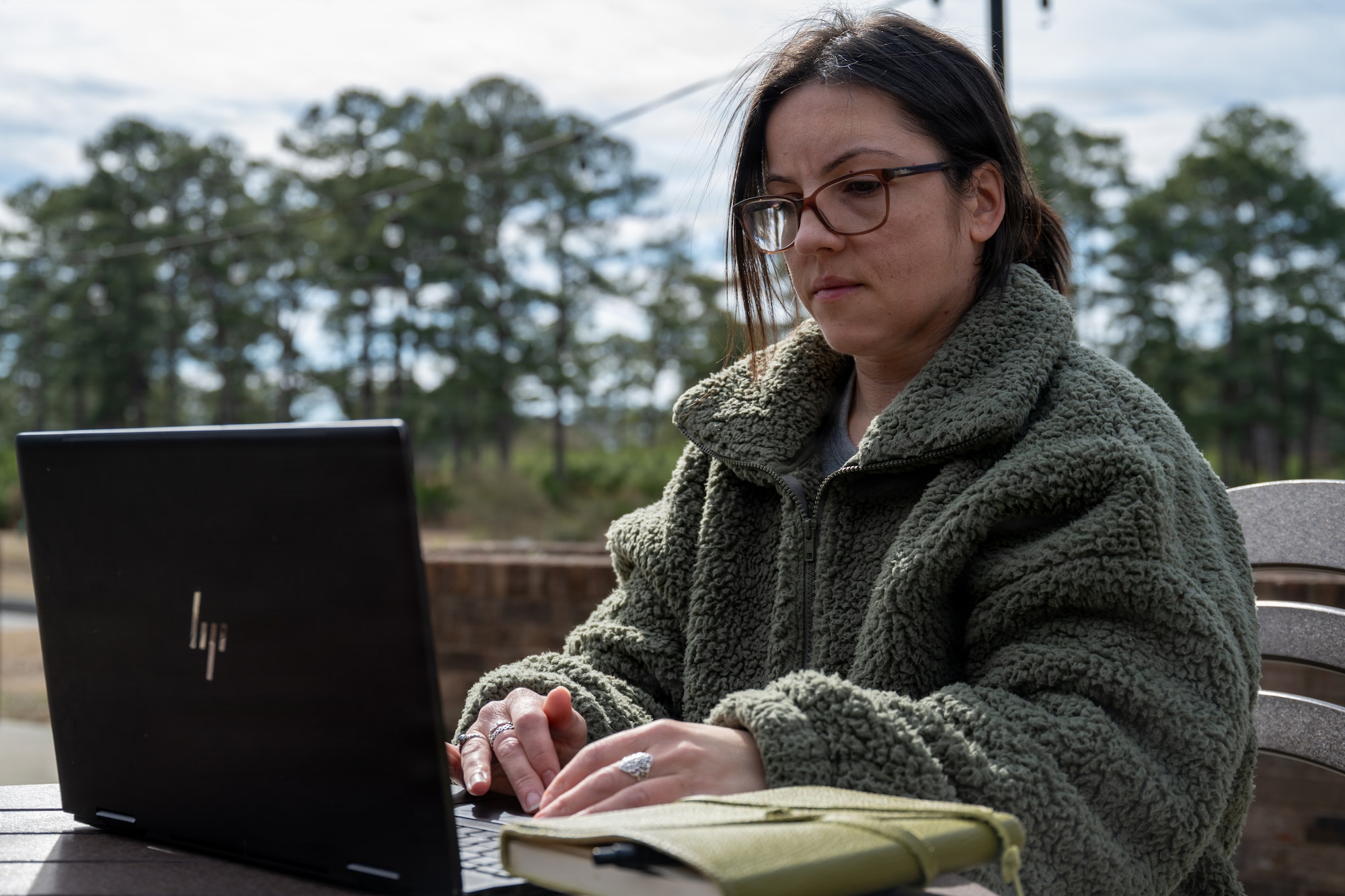 U.S. Air Force Staff Sgt. Alison Gandulla, 4th Contracting Squadron contract specialist, composes poetry on her laptop at Seymour Johnson Air Force Base, North Carolina, Feb. 12, 2026. Gandulla uses personal experiences to create poetry that cultivates resilience and mental fortitude. (U.S. Air Force photo by Airman 1st Class Rebecca Tierney)