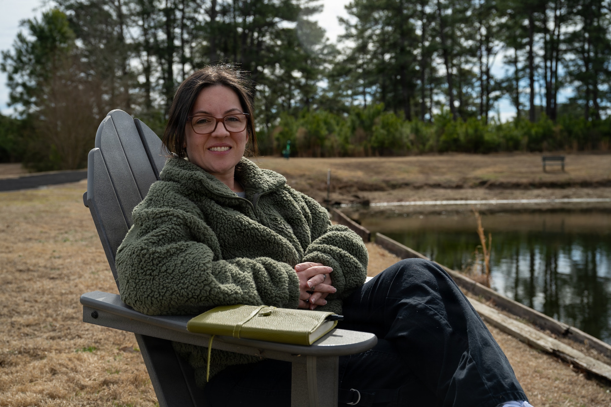 U.S. Air Force Staff Sgt. Alison Gandulla, 4th Contracting Squadron contract specialist, poses for an environmental portrait at Seymour Johnson Air Force Base, North Carolina, March 4, 2025. Gandulla uses personal experiences to create poetry that cultivates resilience and mental fortitude.(U.S. Air Force photo by Airman 1st Class Rebecca Tierney)