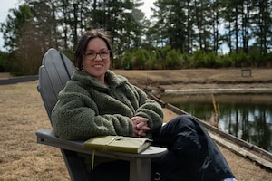 U.S. Air Force Staff Sgt. Alison Gandulla, 4th Contracting Squadron contract specialist, poses for an environmental portrait at Seymour Johnson Air Force Base, North Carolina, March 4, 2025. Gandulla uses personal experiences to create poetry that cultivates resilience and mental fortitude.(U.S. Air Force photo by Airman 1st Class Rebecca Tierney)