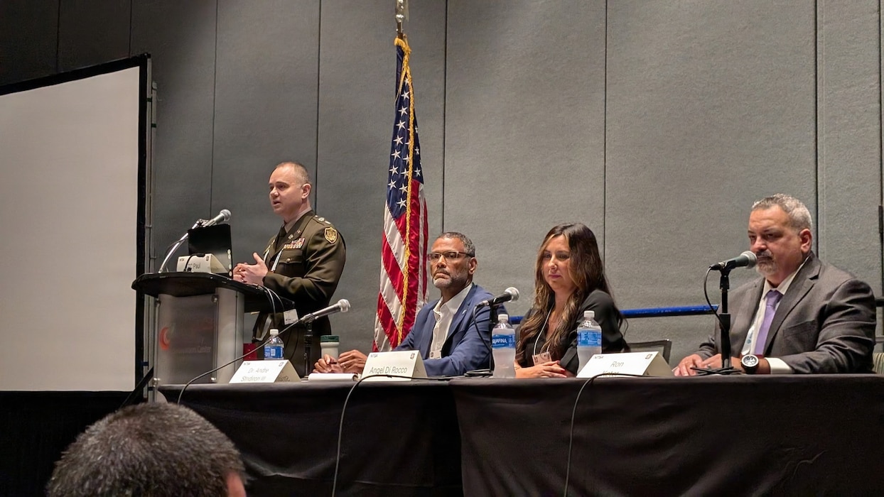 U.S. Indo-Pacific Command’s J708 Pacific Multi Domain Training and Experimentation Capability Program Manager, Dr. Andre Stridiron III (seated, left), stresses the importance of integrating training capabilities in space, cyber, and the electromagnetic spectrum, as a panelist at the 2025 Interservice/Industry Training, Simulation and Education Conference, December 4, in Orlando, Florida.