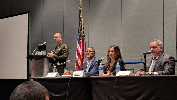 U.S. Indo-Pacific Command’s J708 Pacific Multi Domain Training and Experimentation Capability Program Manager, Dr. Andre Stridiron III (seated, left), stresses the importance of integrating training capabilities in space, cyber, and the electromagnetic spectrum, as a panelist at the 2025 Interservice/Industry Training, Simulation and Education Conference, December 4, in Orlando, Florida.