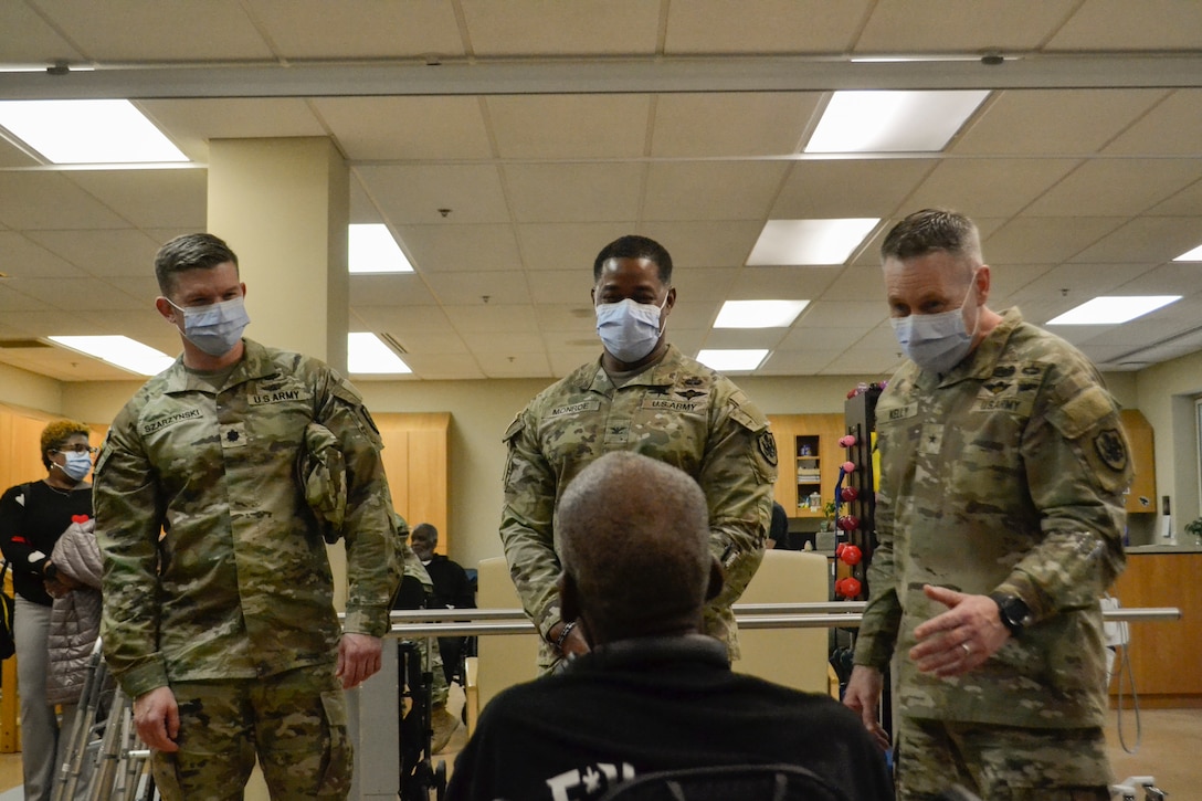 U.S. Army Brig. Gen. Sean Kelly, commanding general of the Defense Logistics Agency Troop Support, and two Soldiers speak with a U.S. military veteran at the Corporal Michael J. Crescenz Department of Veterans Affairs Medical Center in Philadelphia, Pennsylvania, Feb. 11, 2026. The visit was part of National Salute to Veteran Patients Week, during which a delegation from DLA Troop Support met with patients to honor their service and reaffirm the lifelong bond between generations of service members.