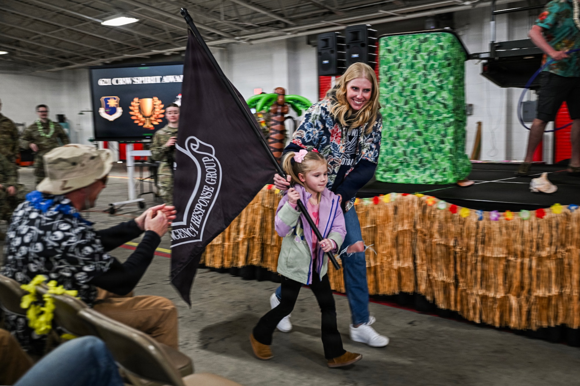 Woman and child walk with flag.