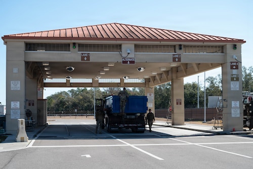 Airmen from 6th Security Forces Squadron inspect a vehicle at MacDill Air Force Base, Florida, Feb. 9, 2026. The 6th SFS implemented a new process at Tanker Way Gate to streamline installation access for delivery and commercial vehicles, including household goods shipments. (U.S. Air Force photo by Airman 1st Class Autumn Lindor)