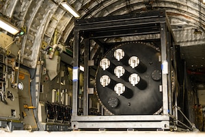 A nuclear reactor module sits secured inside the cargo bay of a C‑17 aircraft.