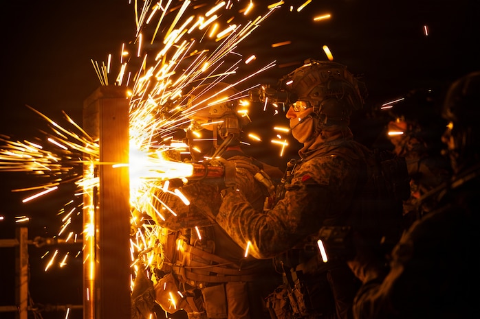 U.S. Marines with Maritime Raid Force, 31st Marine Expeditionary Unit, breach a simulated point of entry during a visit, board, search and seizure (VBSS) operation aboard the landing dock transport ship, USS San Diego (LPD 22) in the Philippine Sea, Feb. 6, 2026