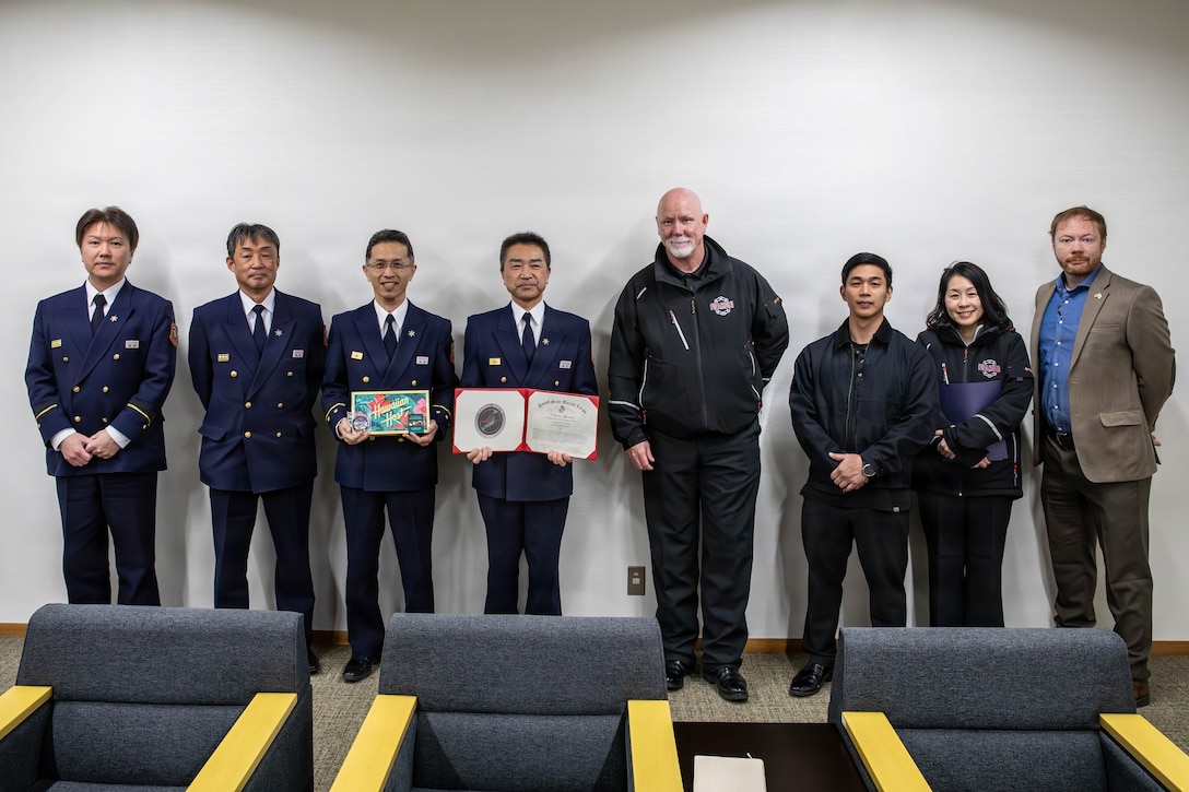 Marine Corps Air Station Iwakuni representatives pose for a photo with Iwakuni Fire Department representatives during an awards presentation in Iwakuni city, Japan, February 10, 2026. Iwakuni Fire Department was presented a certificate of appreciation recognizing their support during exercise Nankai Rescue 2026. Nankai Rescue 2026 is a full-scale exercise focused on enhancing the bilateral coordination between the U.S. and Japan in support of humanitarian and disaster relief efforts. (U.S. Marine Corps photo by Lance Cpl. Donald Dugger)