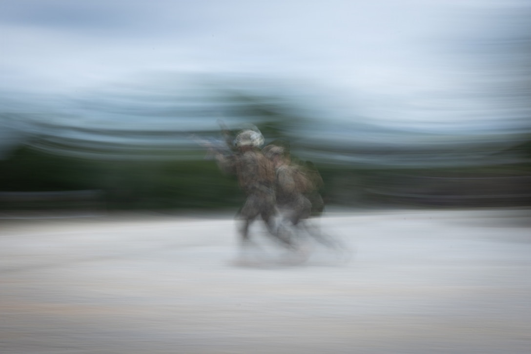 U.S. Marine Corps Pvt. Sidney Jimenez, left, a rifleman with 12th Littoral Combat Team, 12th Marine Littoral Regiment, 3rd Marine Division, sprints to engage a target during a small arms live-fire range on Camp Schwab, Okinawa, Japan, Dec. 2, 2025. Live-fire training hones the 12th LCT Marines' marksmanship skills, strengthening their battlefield capabilities, enhancing lethality, and improving overall combat readiness. Jimenez is native of California. (U.S. Marine Corps photo by Lance Cpl. Robert Blanks)