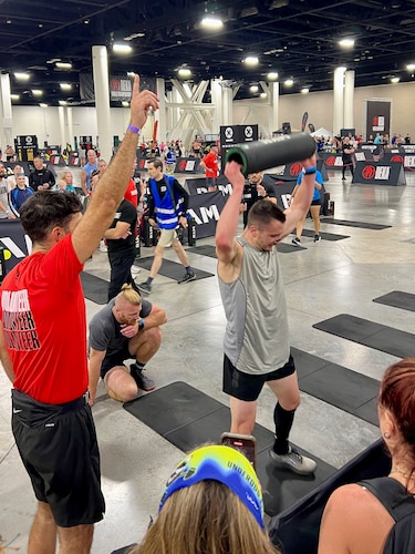 man does burpees at fitness competition