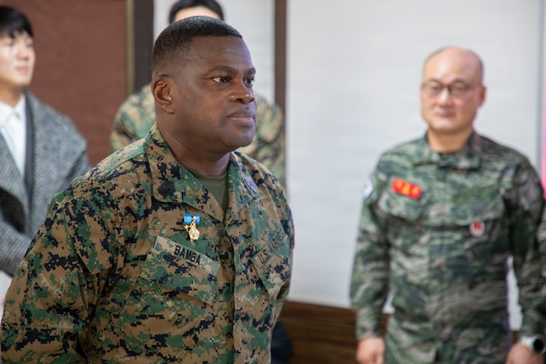 U.S. Marine Corps Sgt. Maj. Ismael G. Bamba, command senior enlisted leader of Marine Forces Korea, stands at attention as his citation is read during his award ceremony at Republic of Korea Marine Corps Headquarters at Camp Baran, South Korea, Feb. 3, 2026. The commendation highlights significant efforts supporting regional stability, alliance readiness and combined operational effectiveness on the Korean Peninsula. (U.S. Marine Corps photo by Gunnery Sgt. Antonio Campbell)
