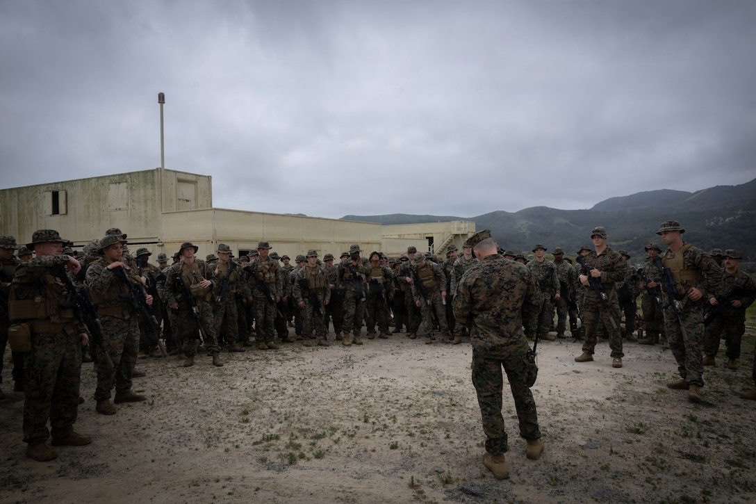 U.S. Marines with 1st Battalion, 25th Marine Regiment listen to a safety brief for the Military Operations on Urbanized Terrain (MOUT) training segment during the Intermediate Location 

(ILOC) event held at Camp Pendleton, California, Feb. 10, 2026. ILOC is a pre-deployment event to ensure combat readiness, emphasizing small-unit leadership roles and responsibilities. (U.S. Marine Corps photo by Lance Cpl. Claire Cheney)