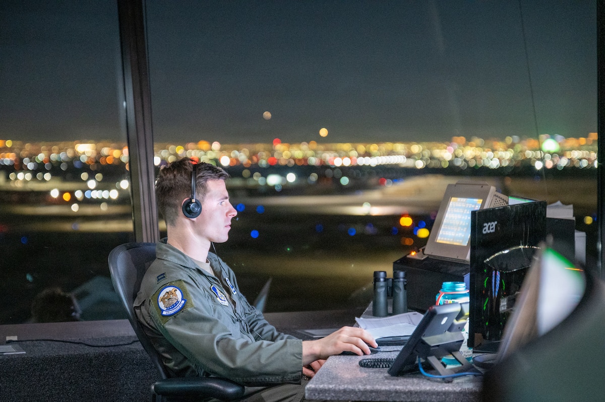 Capt. Clayton Davis, an F-22 pilot and supervisor of flying with the 525th Fighter Squadron, operates from the air traffic control tower in support of exercise Red Flag-Nellis 26-1 at Nellis Air Force Base, Nev., Feb. 2, 2026. During Red Flag, air traffic control personnel manage increased flight operations and complex airspace demands, enabling seamless multinational training missions. (U.S. Air Force photo by Senior Airman Michael Sanders)