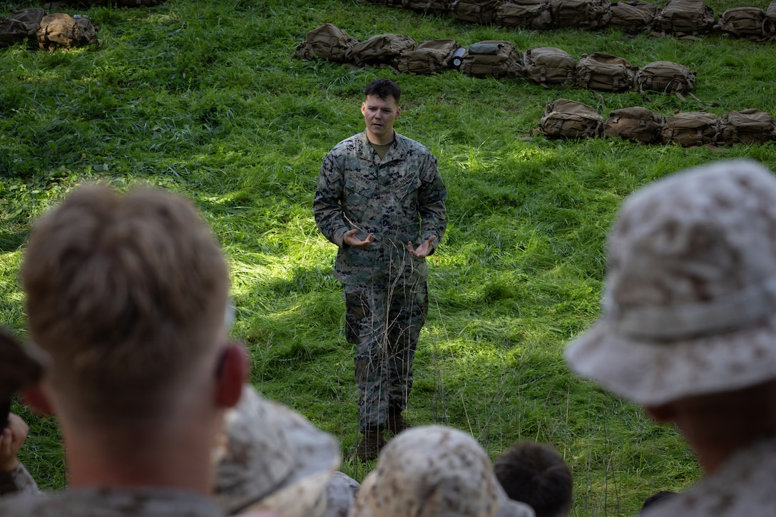 U.S. Marine Corps Lance Cpl. Seth Murray, a chemical, biological, radiological and nuclear defense specialist with 2nd Battalion, 1st Marine Regiment, briefs Marines on wearing gas masks during an Intermediate Location (ILOC) event held at Camp Pendleton, California, Feb. 9, 2026. ILOC is a pre-deployment event to ensure readiness, emphasizing small-unit leadership roles and responsibilities. (U.S. Marine Corps photo by Lance Cpl. Claire Cheney)